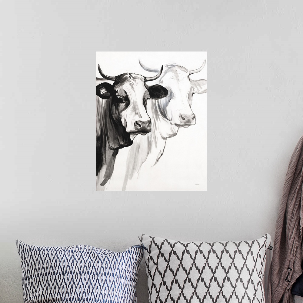 A bohemian room featuring Black and white panting of two cows with horns on a white background.