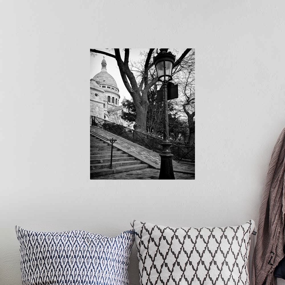 A bohemian room featuring A lamppost and stairway leading up to Sacre Coeur in France.