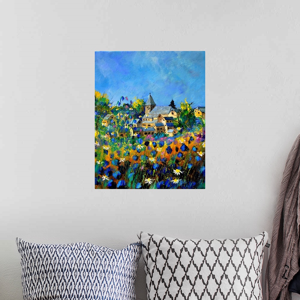 A bohemian room featuring Vertical painting of a field of colorful flowers in the foreground and a Belgium village in the b...