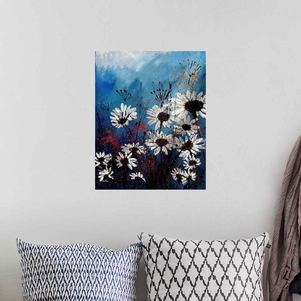 A bohemian room featuring Vertical painting of a group of white daises in front of a blue backdrop.
