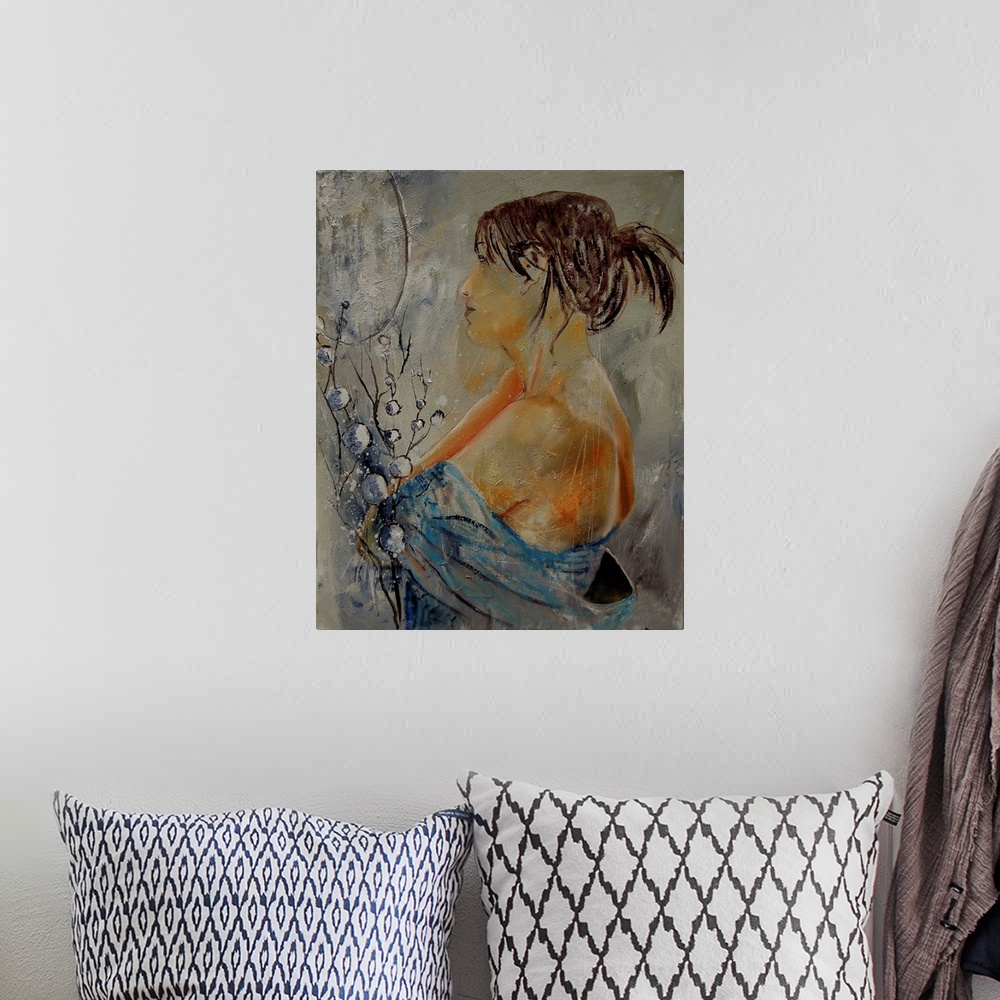 A bohemian room featuring A nude painting of the profile of a woman in textured neutral colors.