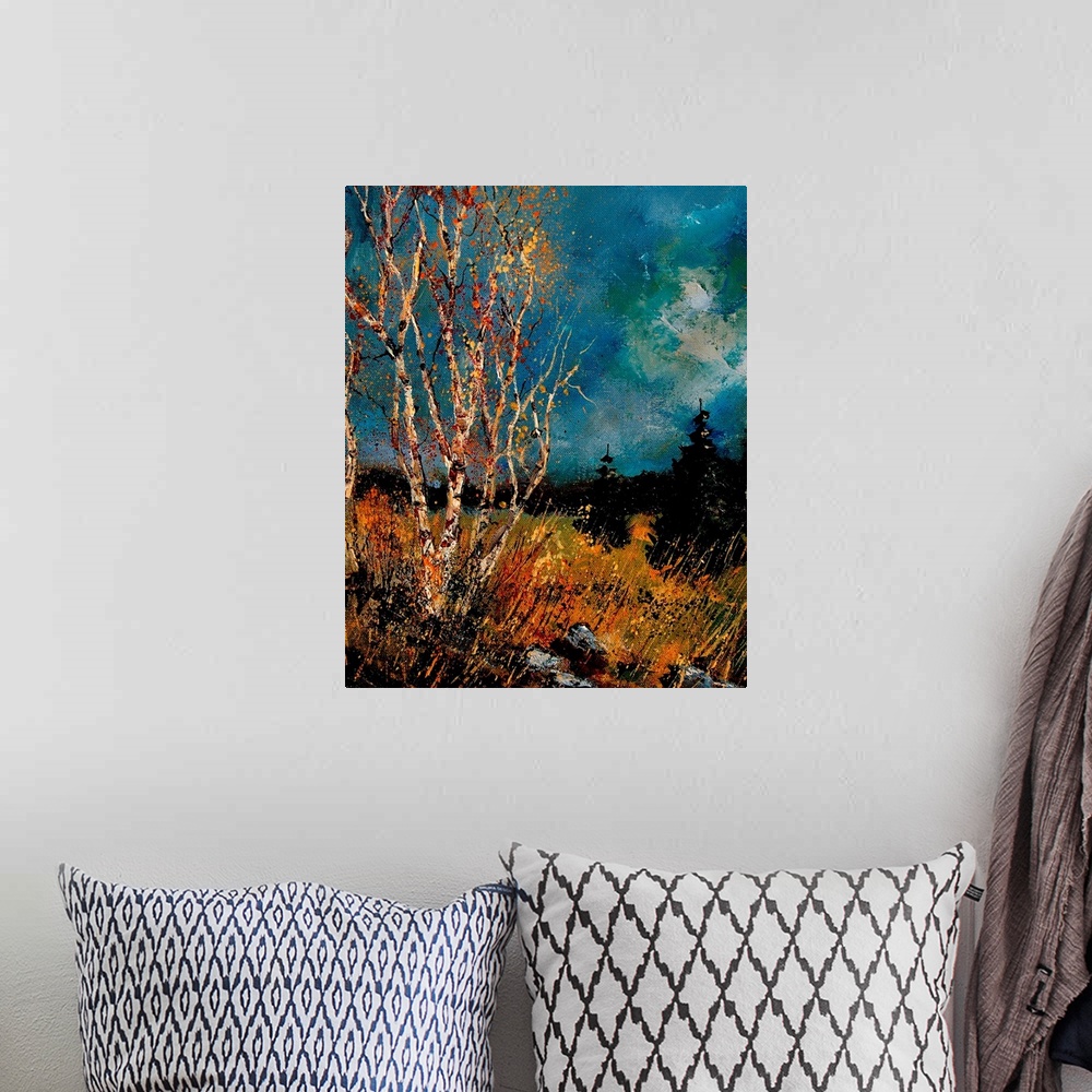 A bohemian room featuring Vertical painting of bare trees in a field of golden grass with a dark stormy sky.