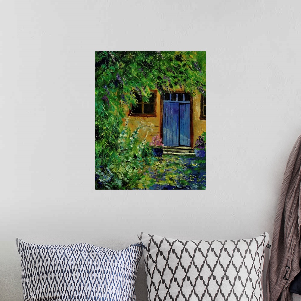 A bohemian room featuring Painting of a blue door to a building surrounded by a overgrown garden.