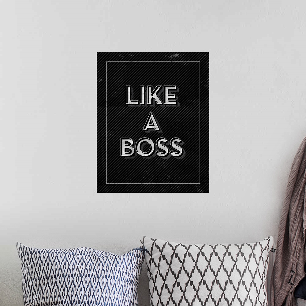 A bohemian room featuring Slightly distressed artwork with the words, "Like A Boss" in black and white.