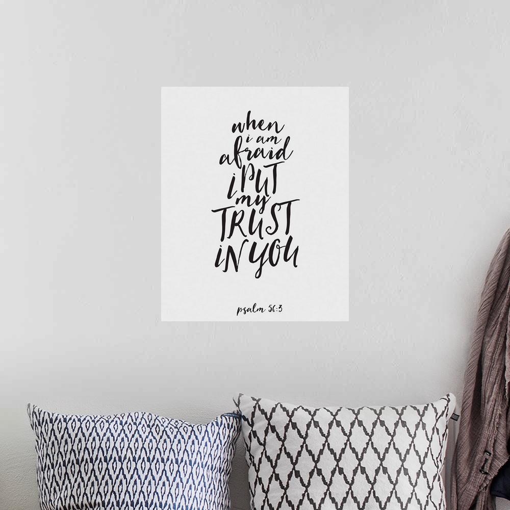 A bohemian room featuring Handlettered Bible verse reading When I am afraid I put my trust in You.