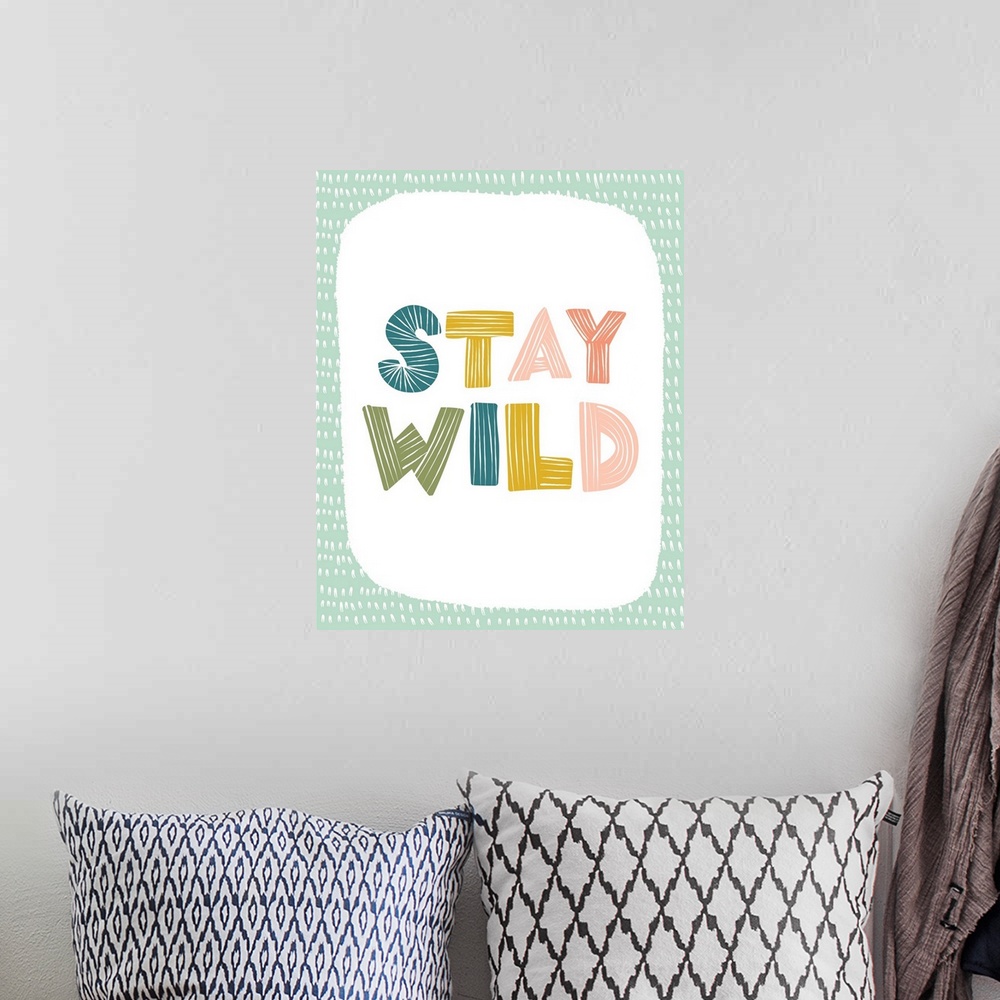 A bohemian room featuring Typography artwork with the words, "Stay Wild".