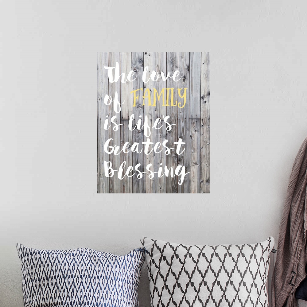 A bohemian room featuring "The love of family is life's greatest blessing" in hand-lettered text over a background of woode...