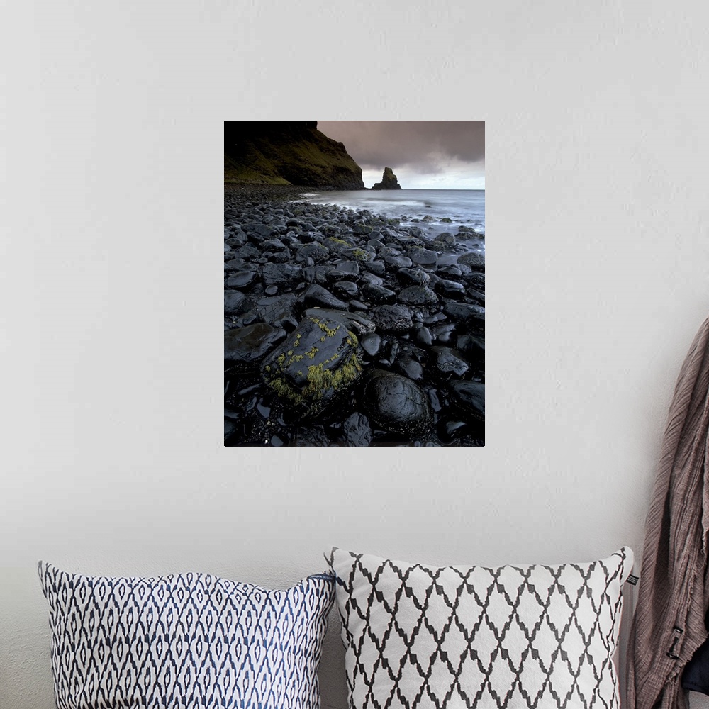 A bohemian room featuring Black boulder rocks in Talisker Bay, Isle of Skye, Inner Hebrides, Scotland, UK