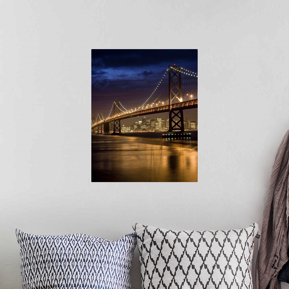 A bohemian room featuring Oakland Bay Bridge and San Francisco skyline at night