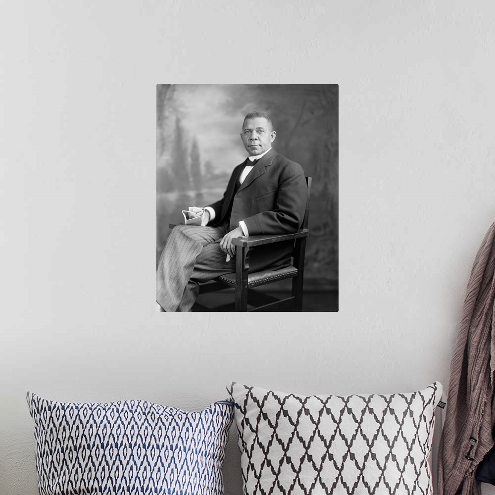 A bohemian room featuring Portrait of Booker T. Washington sitting in a chair.
