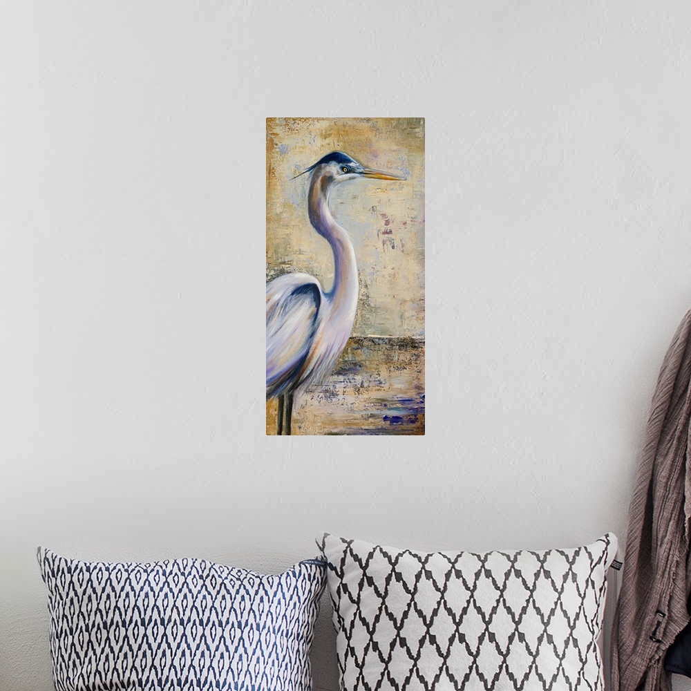 A bohemian room featuring A large vertical piece of a painting of a heron with an antiqued background.