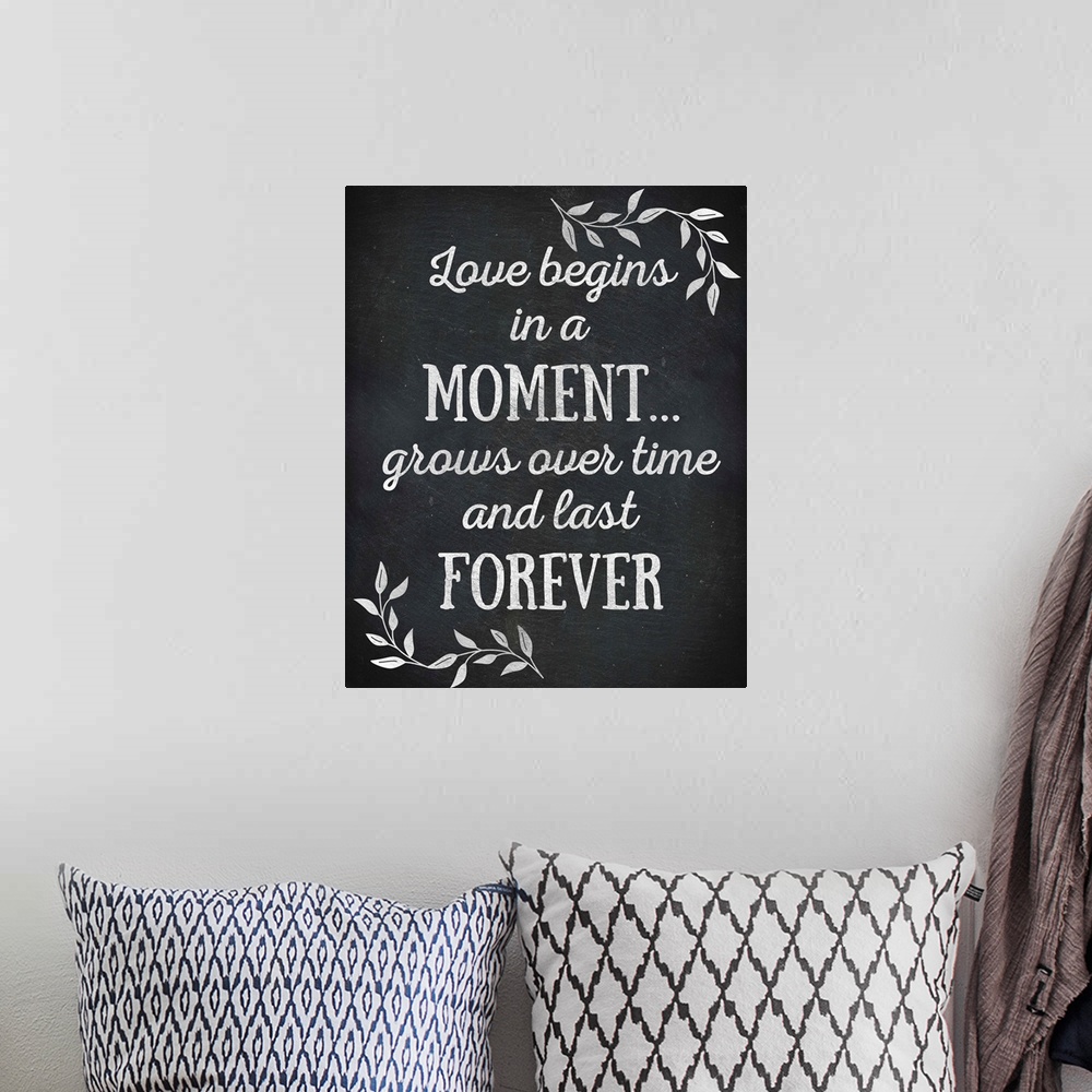 A bohemian room featuring Chalkboard sign that reads "Love begins in a Moment... grows over time and lasts Forever"
