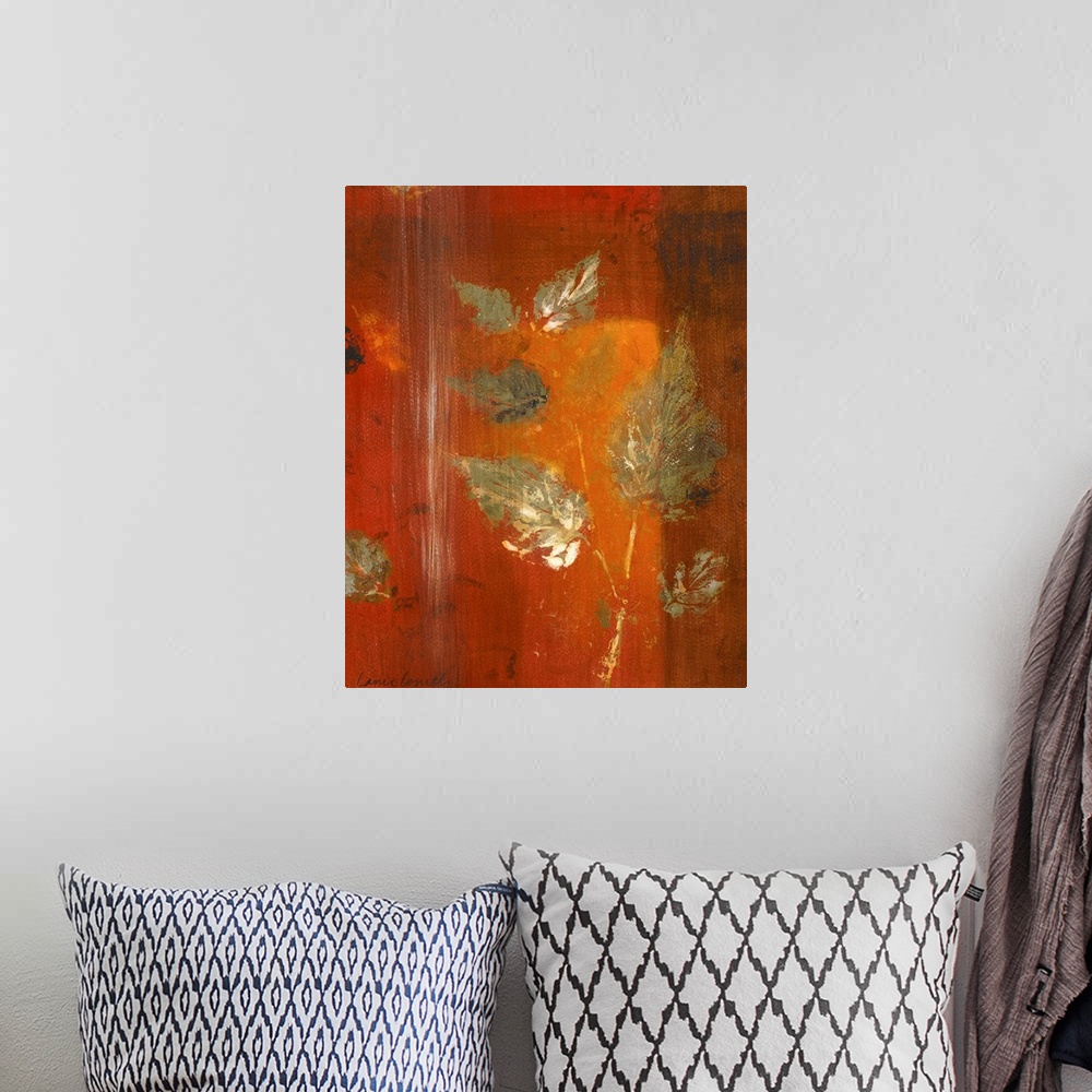 A bohemian room featuring Contemporary artwork in oranges and reds with leaf imprints.