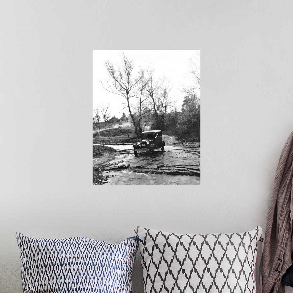 A bohemian room featuring A Model A Ford crossing a creek bed in Oldham County, Kentucky. Photograph, 1930.