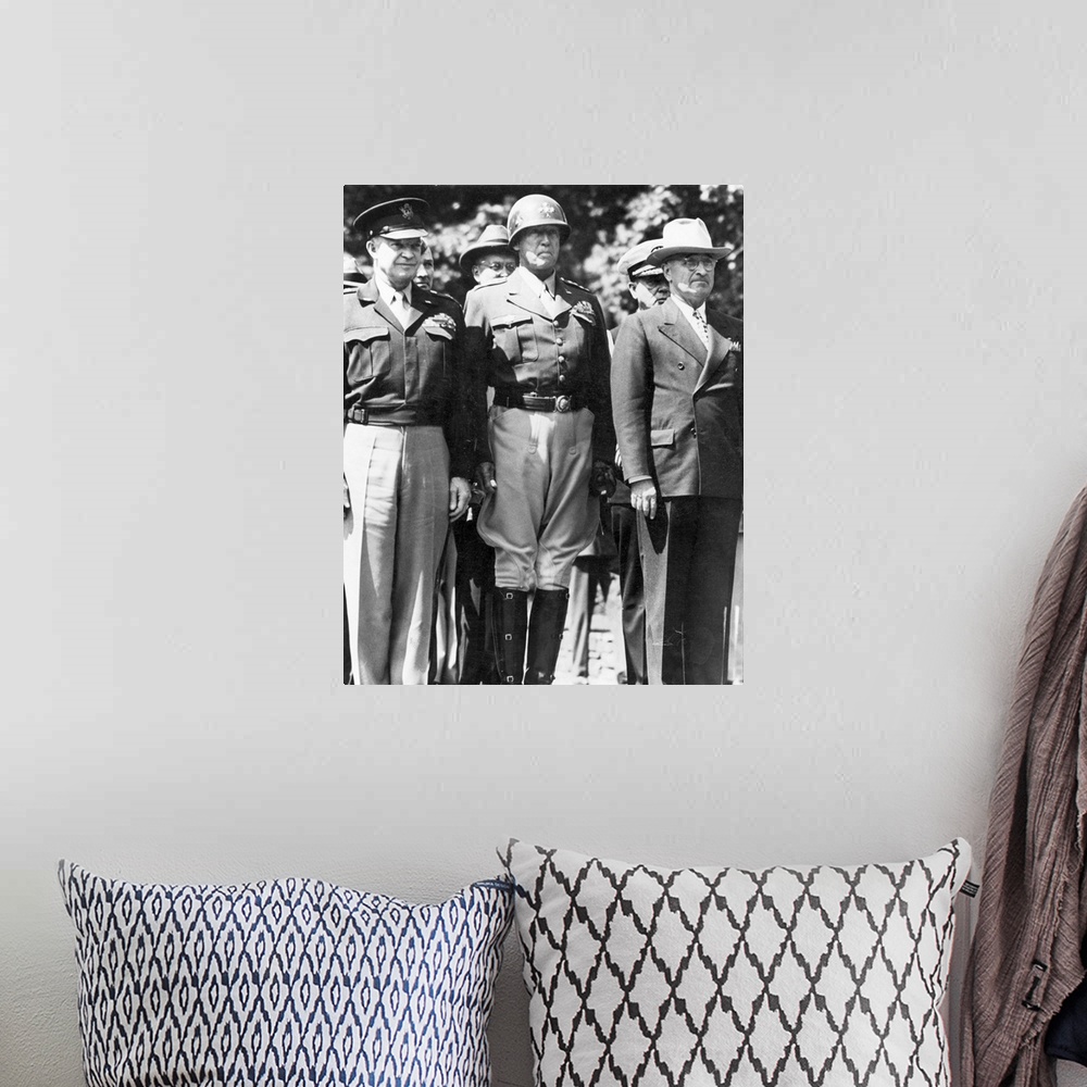 A bohemian room featuring General Dwight D. Eisenhower, General George S. Patton, and President Harry S. Truman watching as...