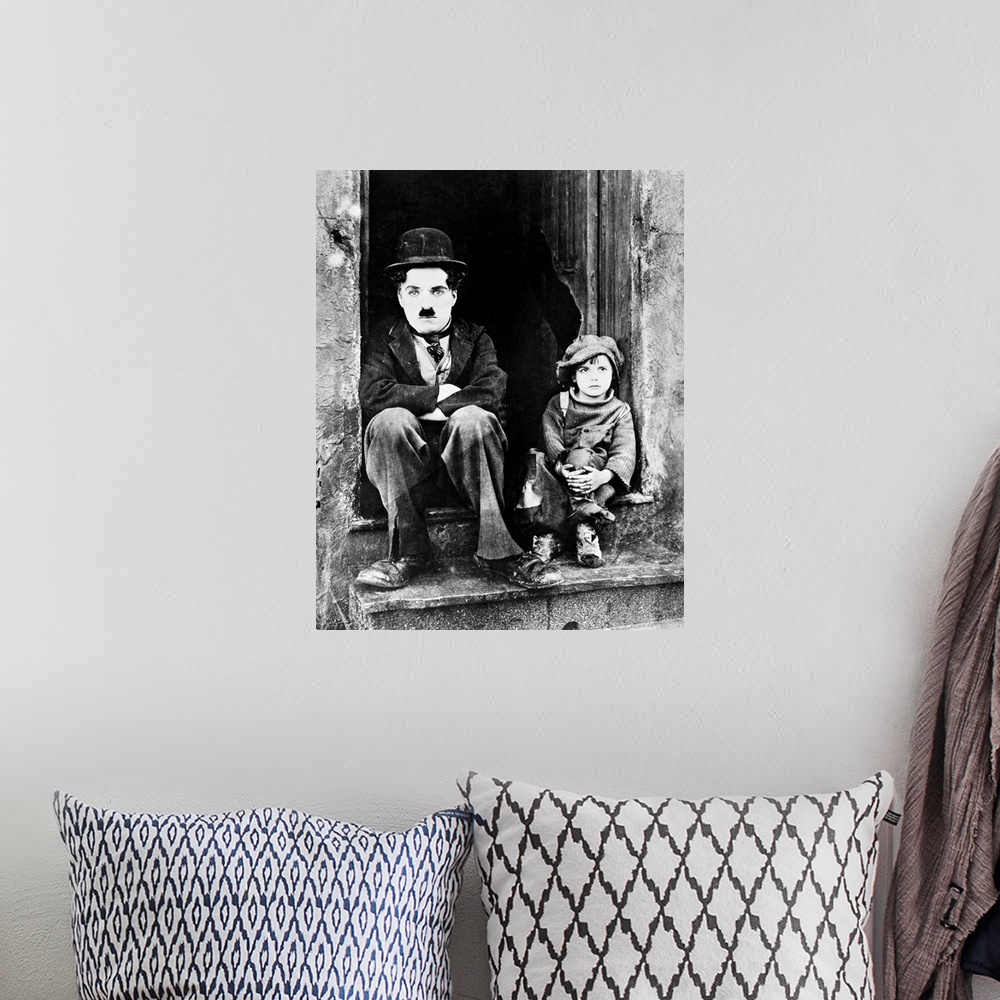A bohemian room featuring Charlie Chaplin and Jackie Coogan as his adopted son in Chaplin's film 'The Kid,' 1921.