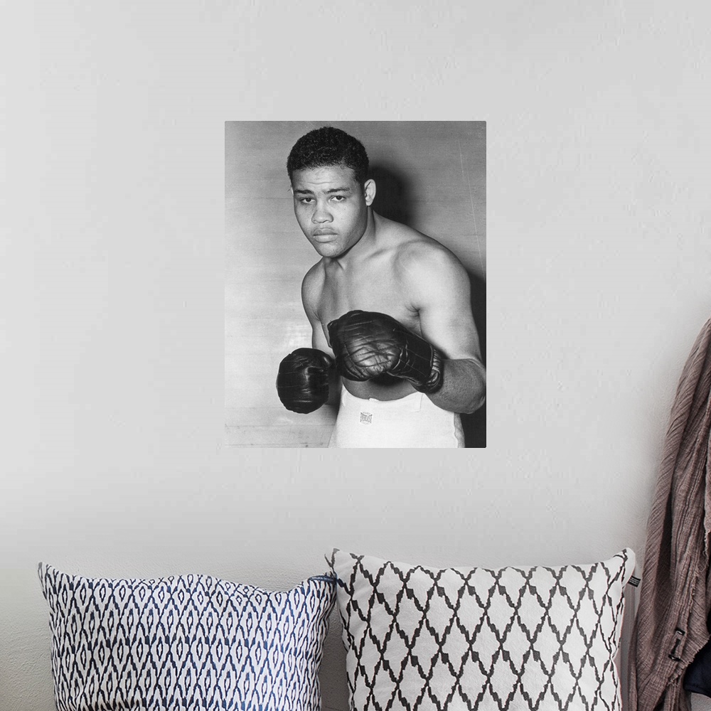 A bohemian room featuring American heavyweight champion pugilist. Photographed in 1938.