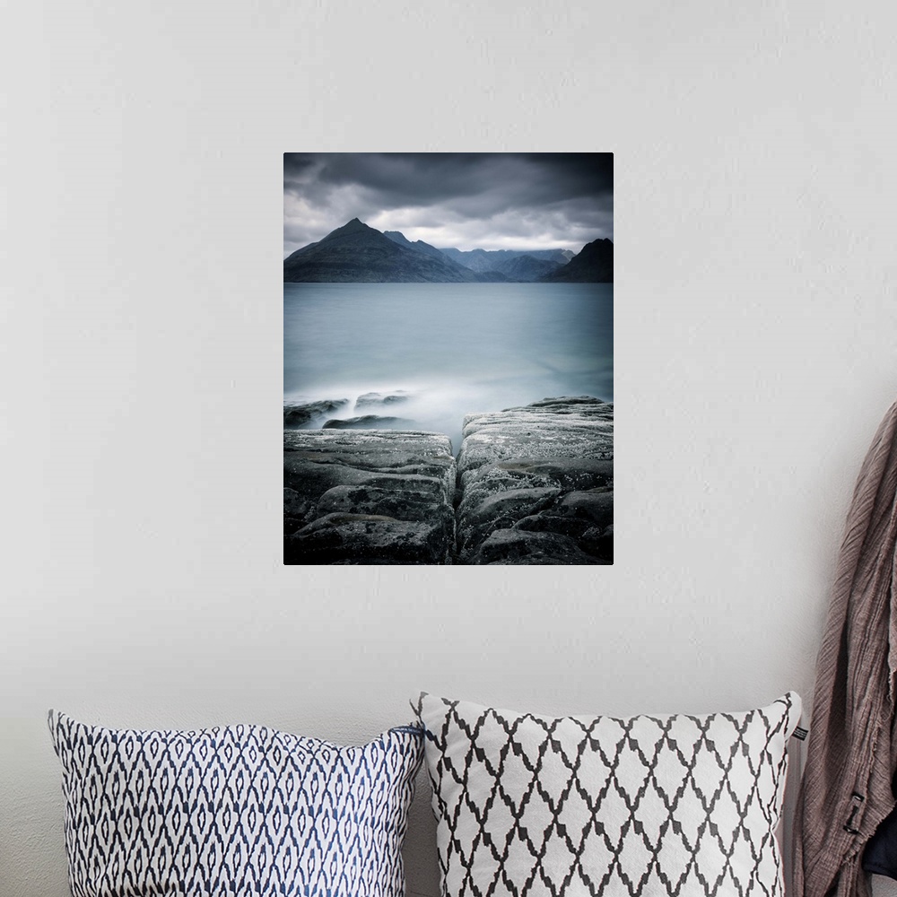 A bohemian room featuring Looking across the sea to the Isle of Skye with mountains under a grey sky