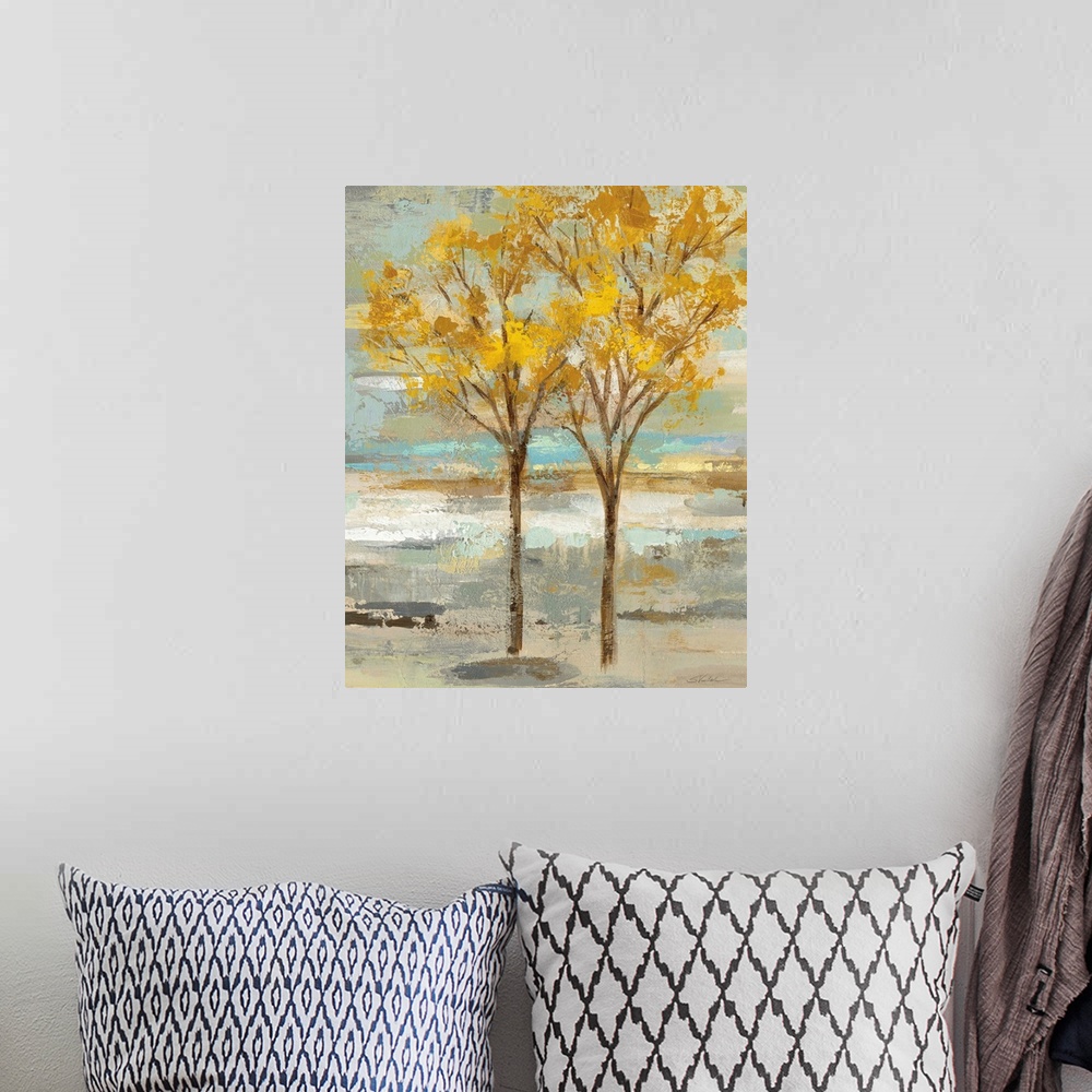 A bohemian room featuring Abstract painting of two golden leafed trees on a colorful background made up of blue, green, tan...
