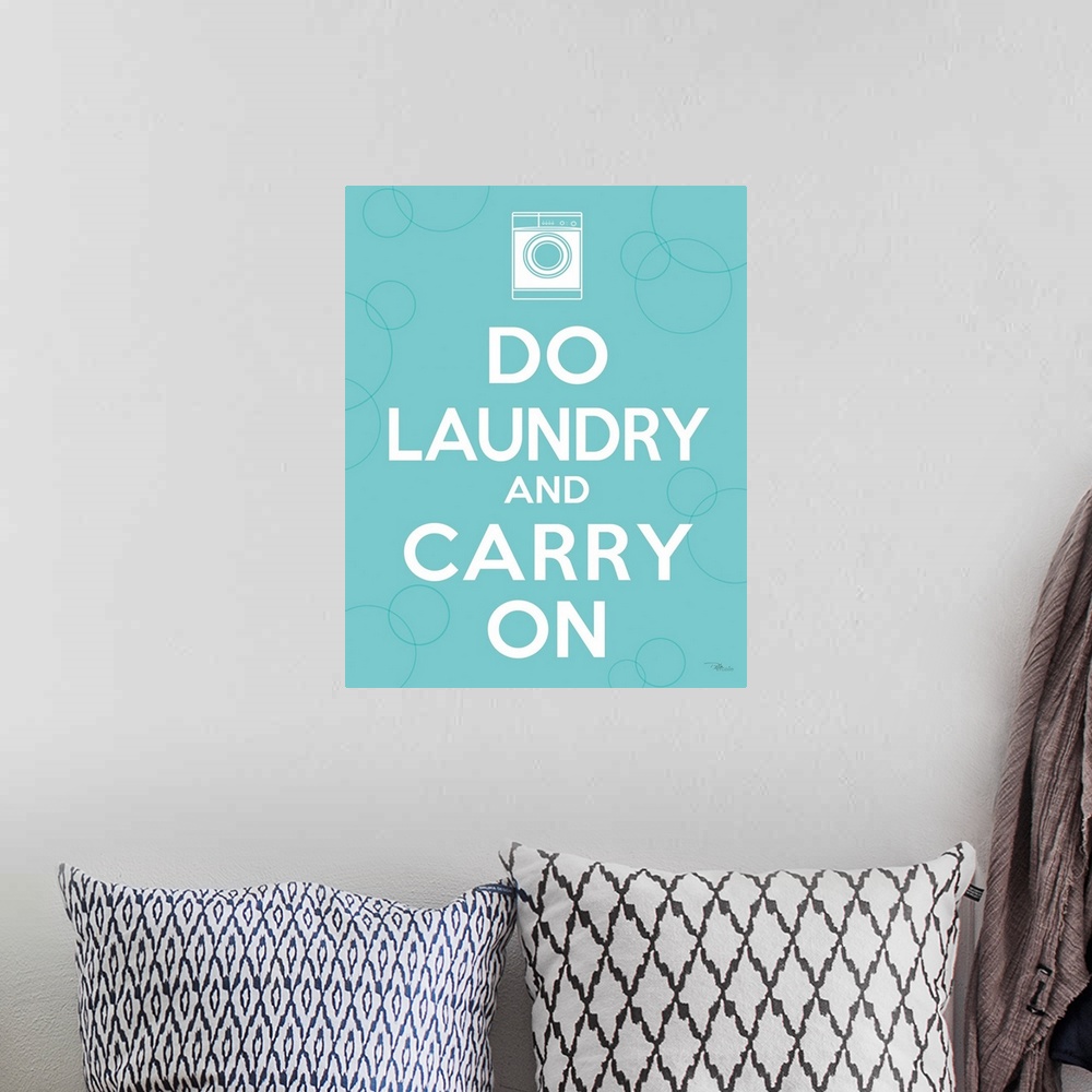 A bohemian room featuring Vertical, big print of white text reading "Do laundry and carry on", a small white illustration o...