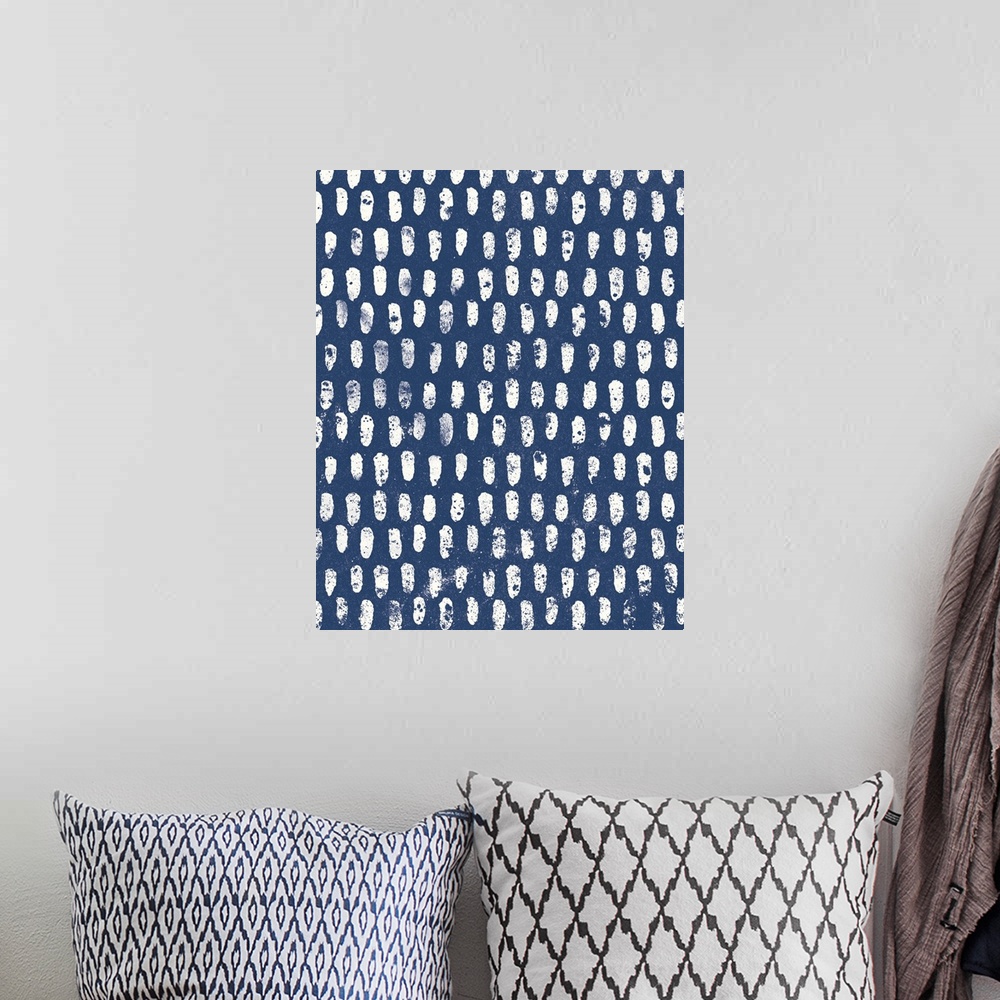 A bohemian room featuring Abstract artwork with white oblong shapes creating a pattern on a navy blue background.