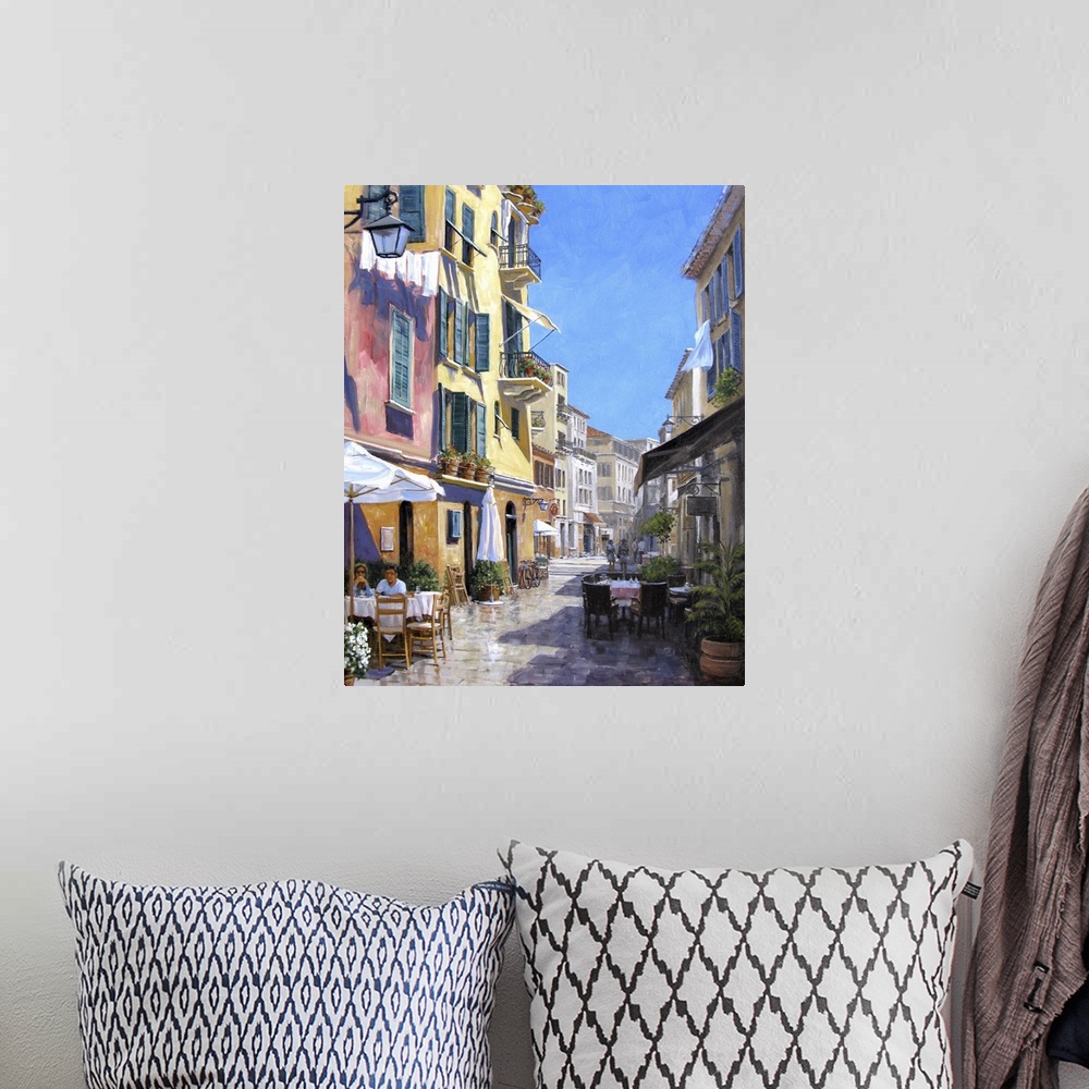 A bohemian room featuring Contemporary artwork of a street scene in the Italian town of Portofino.