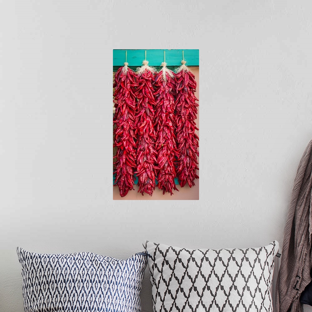A bohemian room featuring Photograph of four strings of dried chilies.