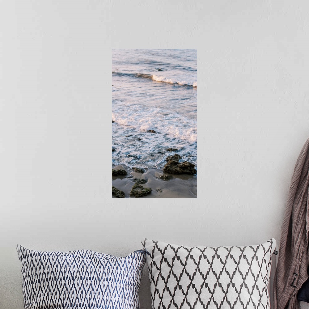 A bohemian room featuring A photograph of gentle waves lapping the beach.