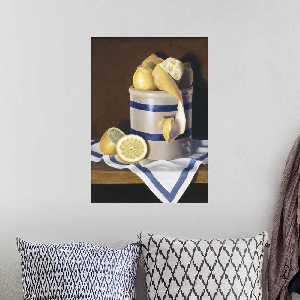 A bohemian room featuring Contemporary vivid still-life artwork of lemons sitting in a white and blue striped ceramic conta...