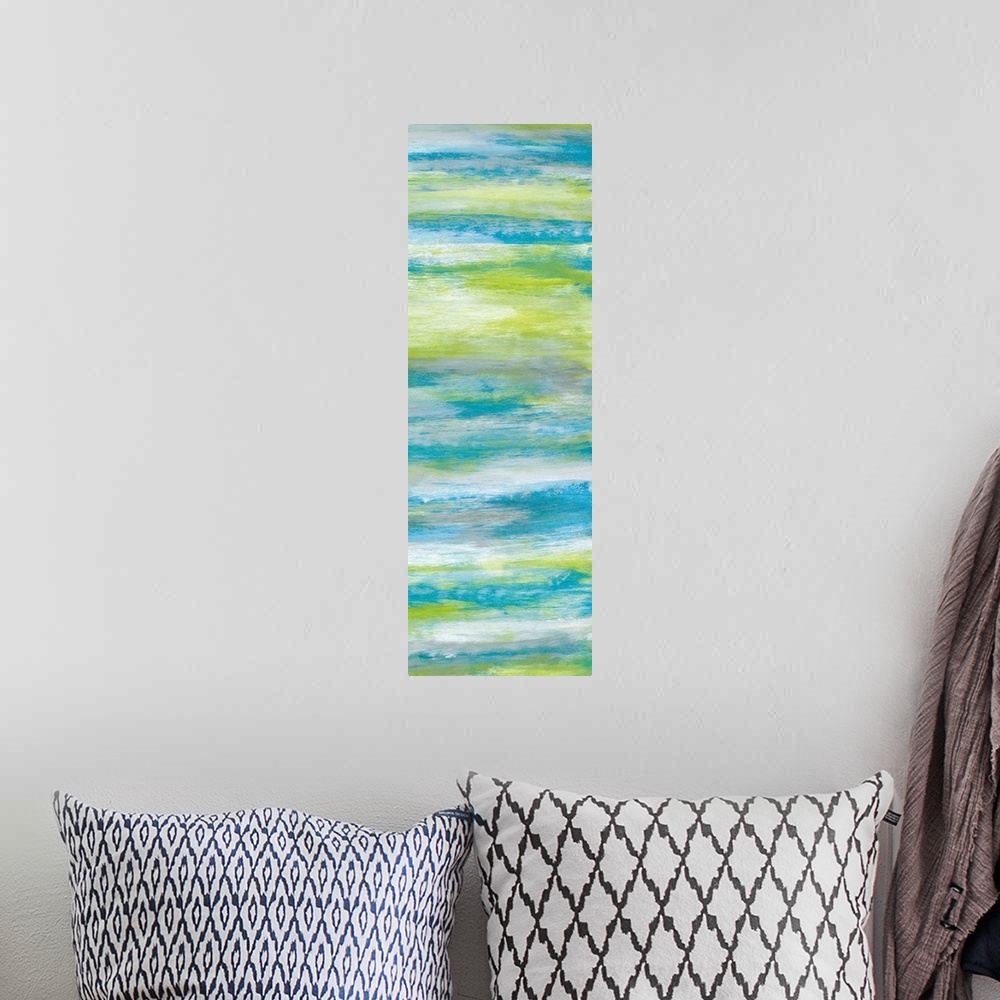 A bohemian room featuring A long abstract painting of bright textured colors in blue, gray and green.