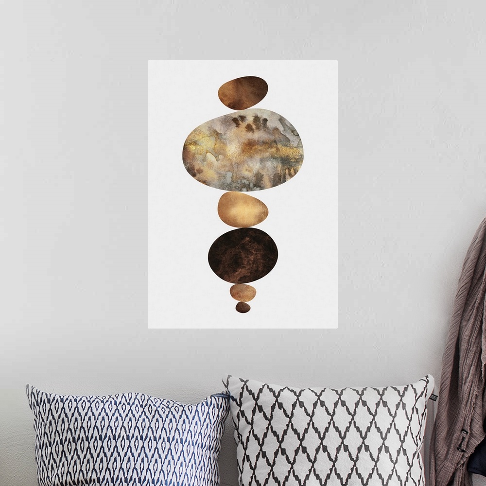 A bohemian room featuring A set of organic oval shapes in metallic brown shades resting atop one another on a white background