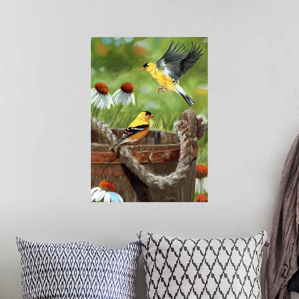 A bohemian room featuring Two goldfinches near a wooden bucket with a rope handle.