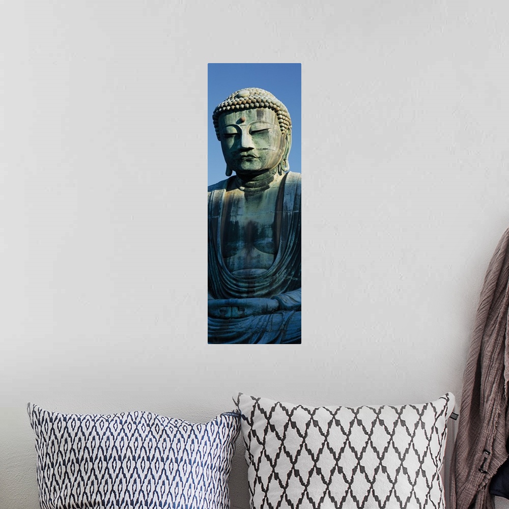 A bohemian room featuring Only part of a Buddha statue is photographed for this tall panoramic piece.