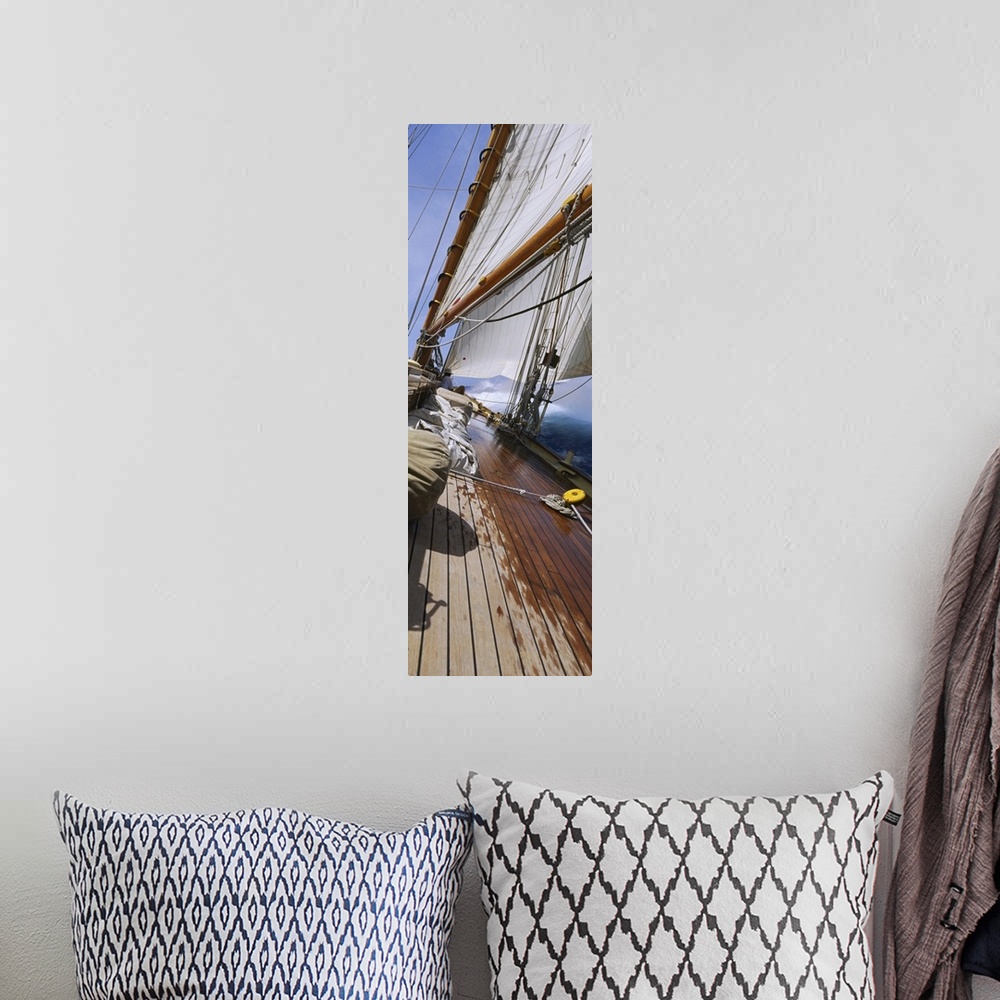 A bohemian room featuring Vertical panorama of the deck of a sail boat as it tips starboard in water with the sails at full...