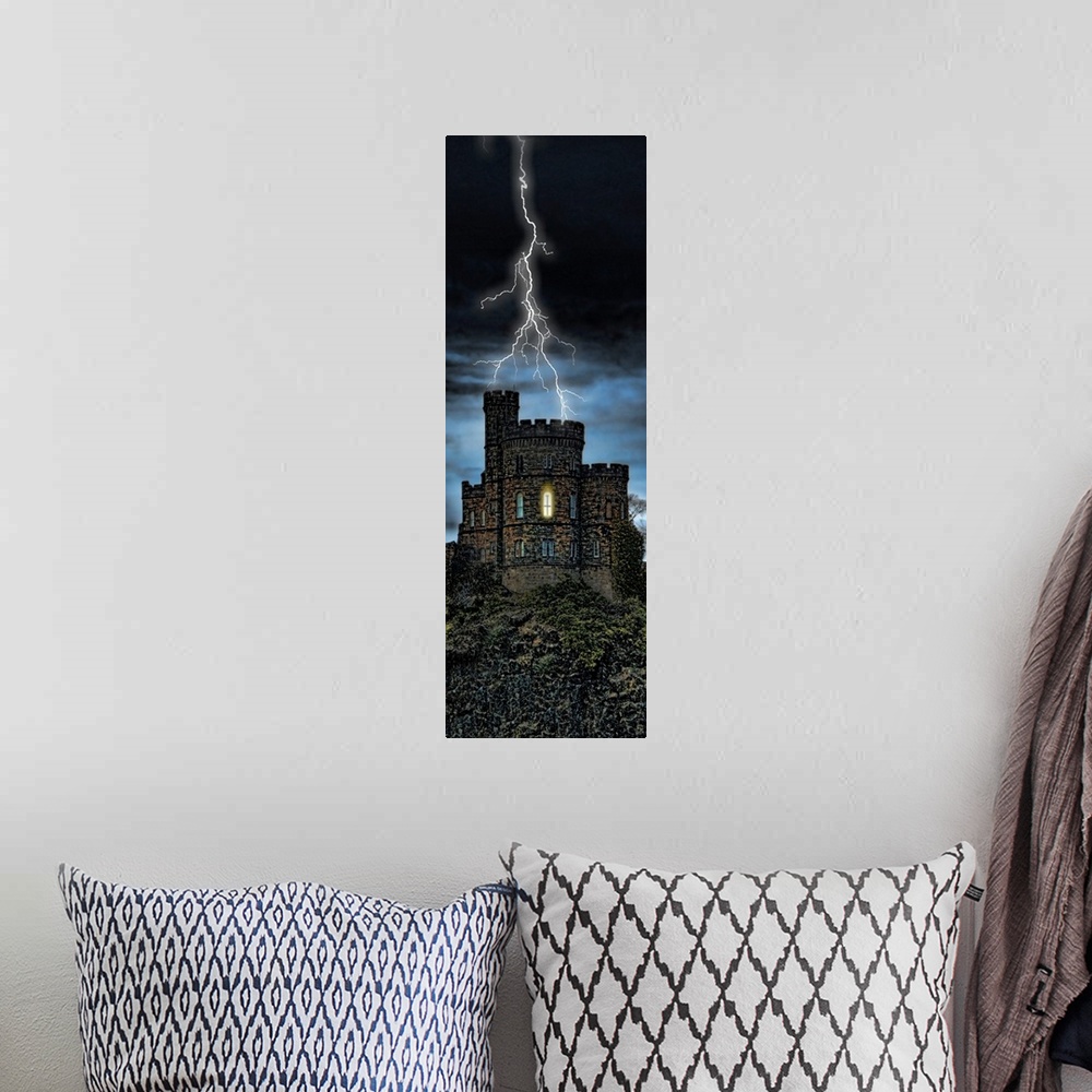 A bohemian room featuring Giant, vertical photograph of lightening striking a castle on a hill, a single light can be seen ...