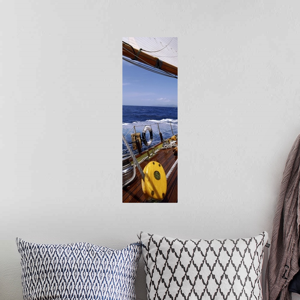A bohemian room featuring This photograph is taken on a sailboat showing the detail of the deck on the boat and side railing.