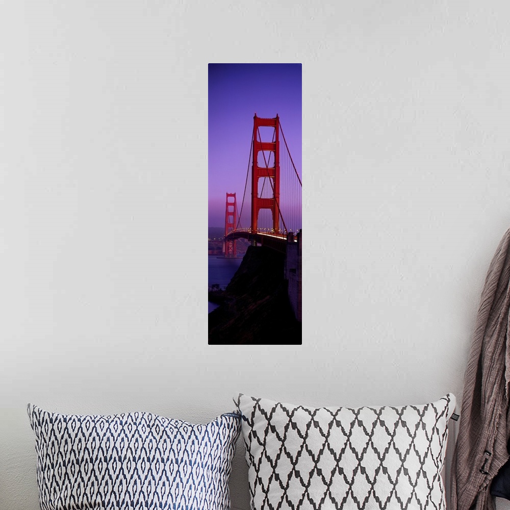A bohemian room featuring Oversized, vertical photograph taken at an angle of the Golden Gate Bridge at dusk, in San Franci...