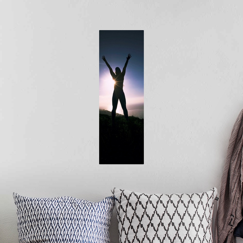 A bohemian room featuring Low angle view of a young woman exercising on a hill