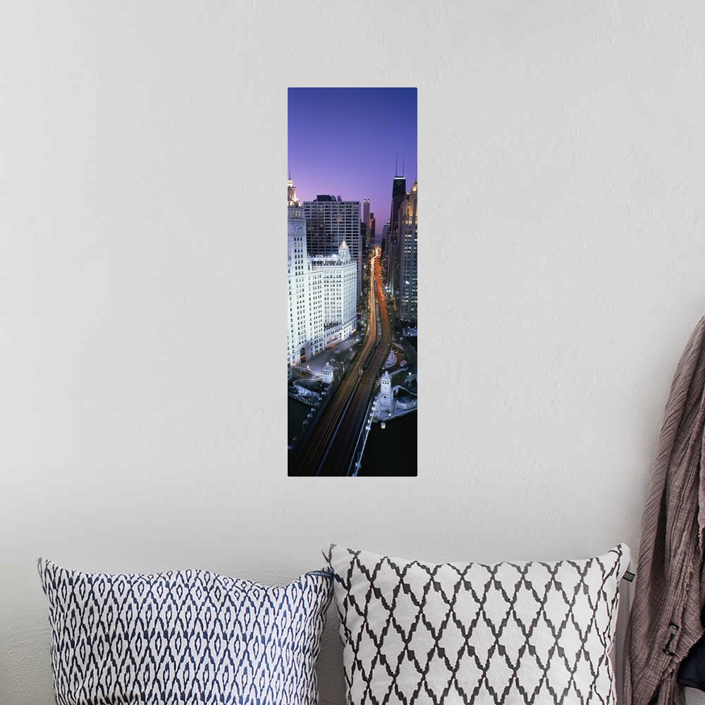 A bohemian room featuring A photograph of a busy street going through downtown Chicago at night with the lights of the cars...
