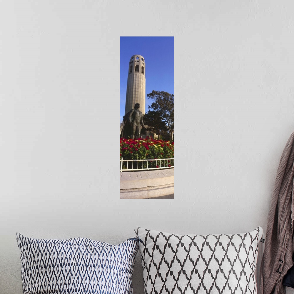 A bohemian room featuring Statue of Christopher Columbus in front of a tower, Coit Tower, Telegraph Hill, San Francisco, Ca...