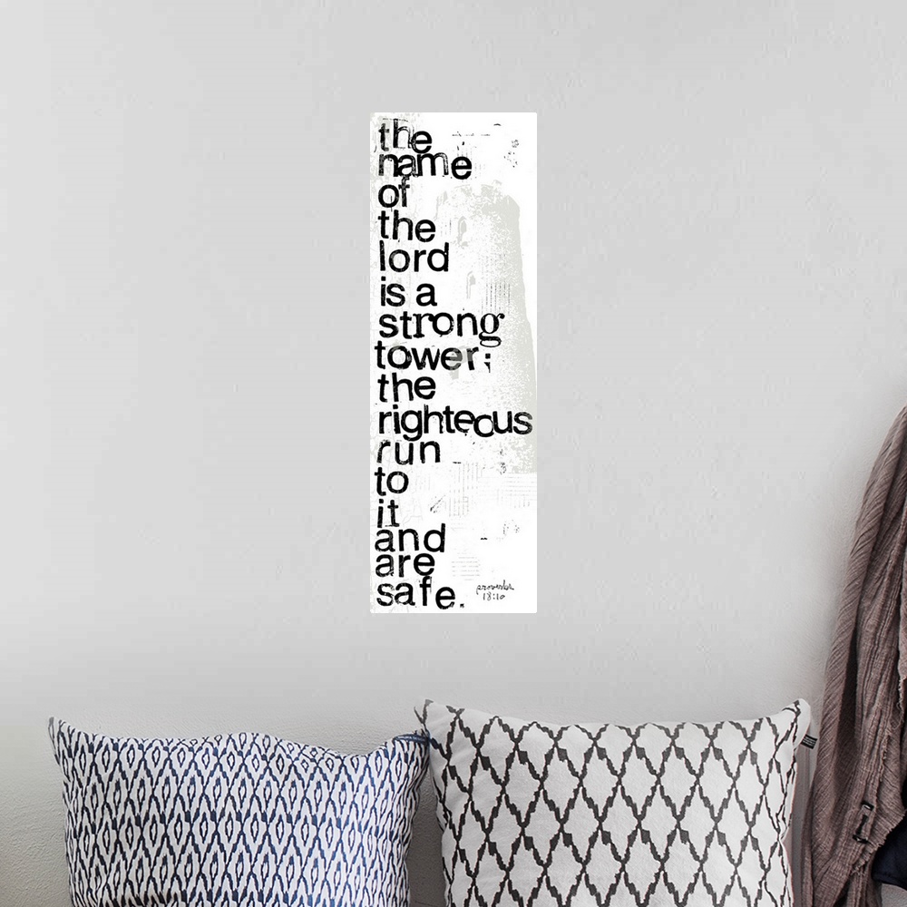 A bohemian room featuring Distressed black and white letter-stamped Bible verse scripture of Proverbs 18:10 The name of the...