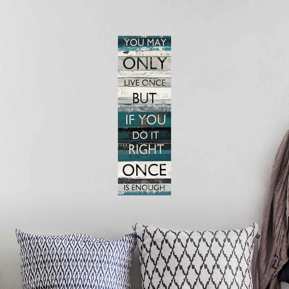 A bohemian room featuring Contemporary artwork of lines of text stacked vertically against a background of different blue t...