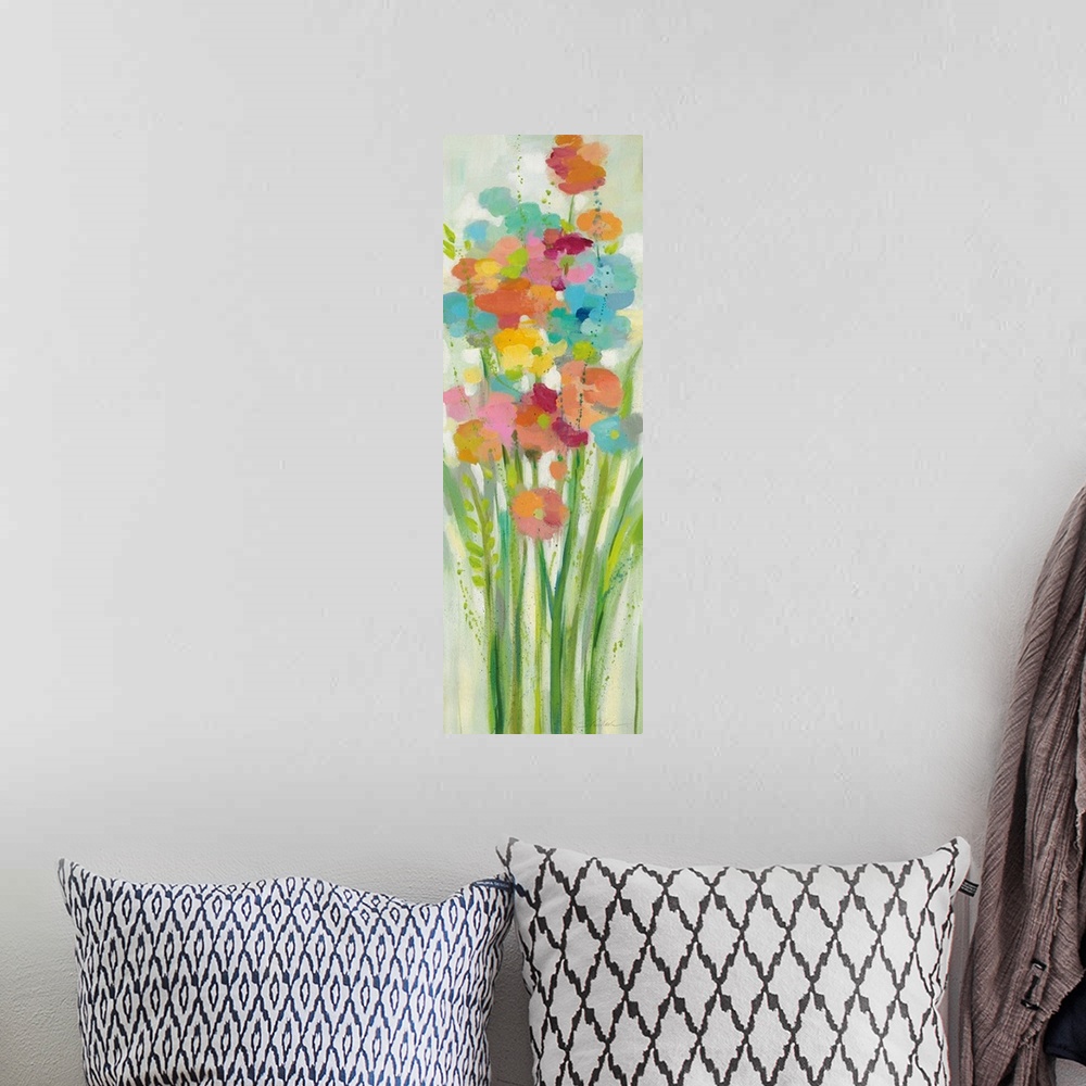 A bohemian room featuring A long vertical painting of a group of stemmed flowers and leaves in cheerful colors.