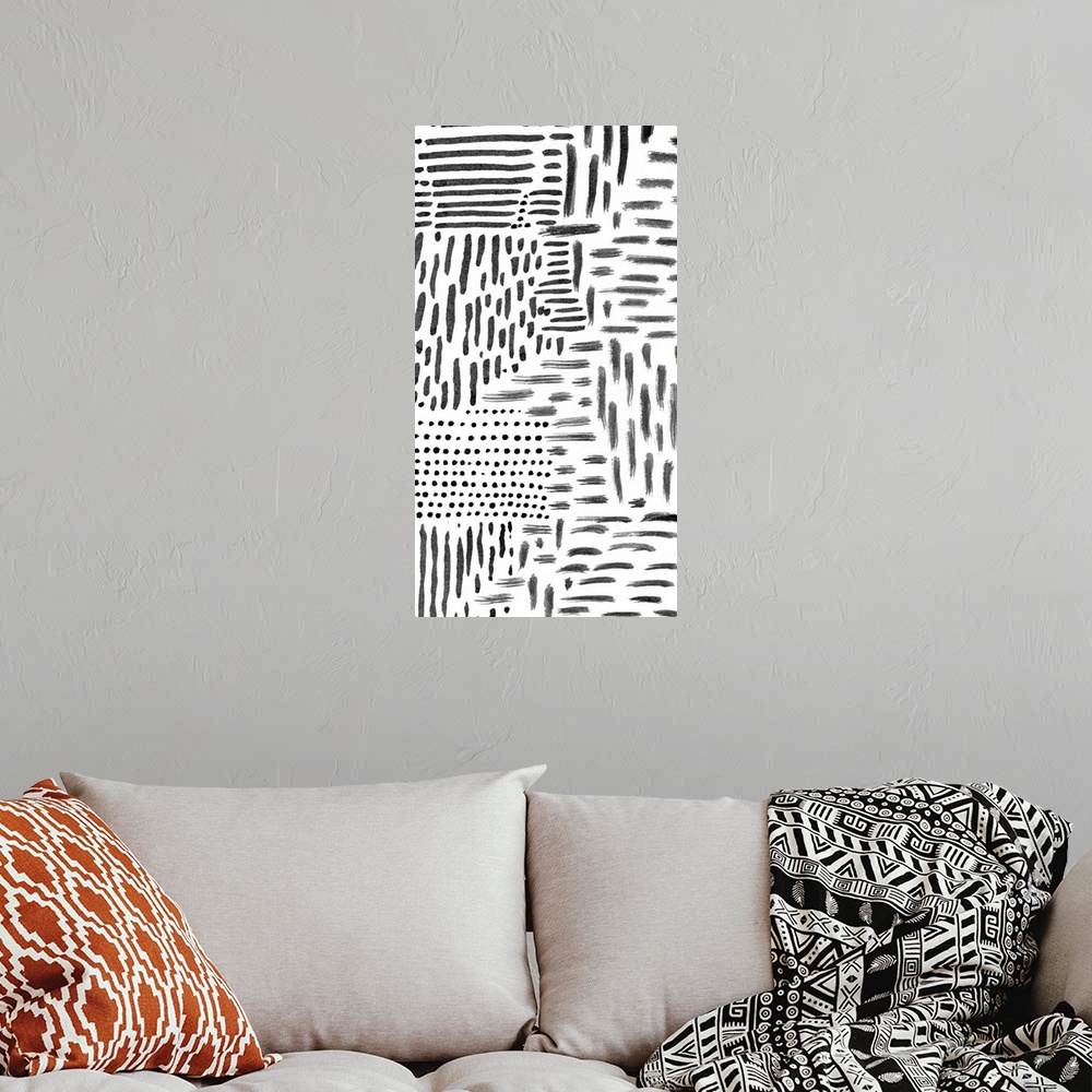 A bohemian room featuring Abstract painting of black marks and streaks on white.