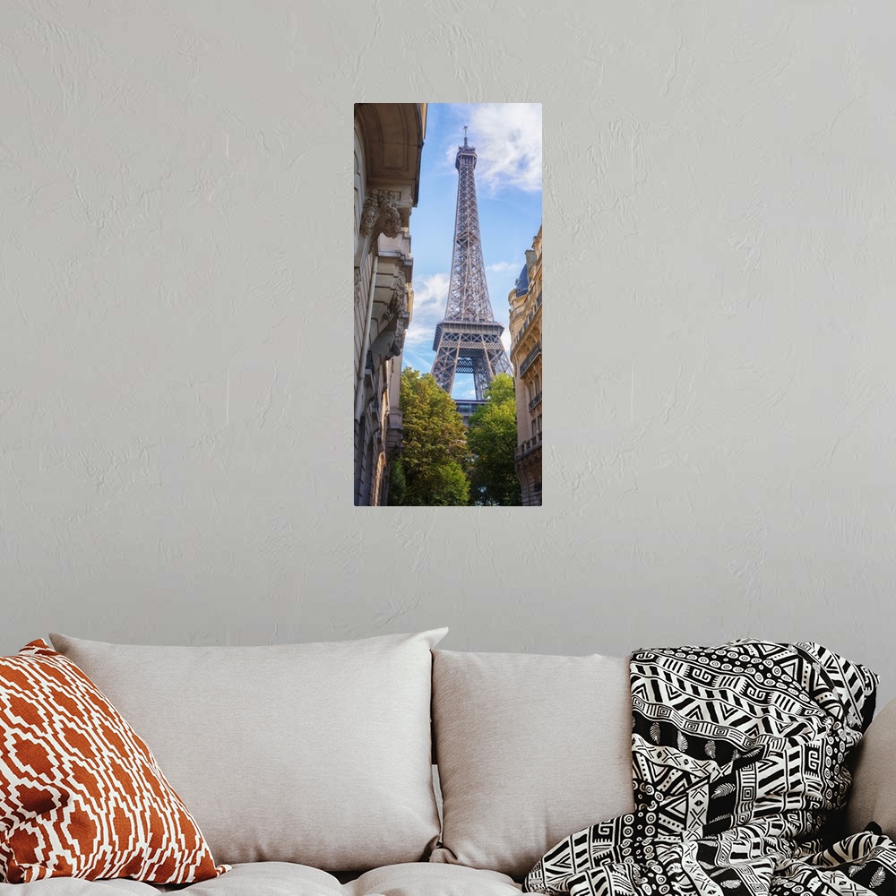 A bohemian room featuring Eiffel tower between typical buildings and trees from the champ de Mars area. Vertical view with ...