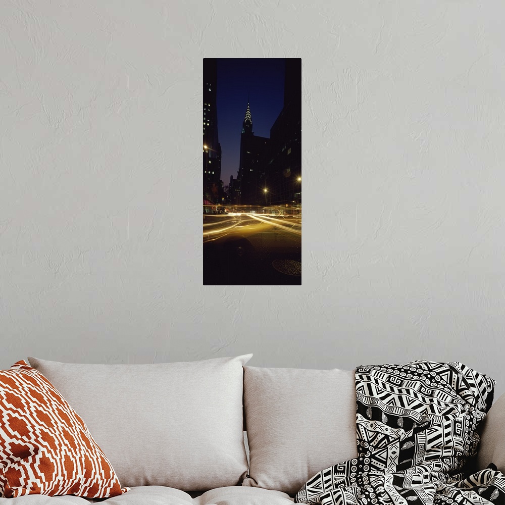 A bohemian room featuring Vertical panoramic photograph of street with light trails lined with lit up buildings in the ""Bi...