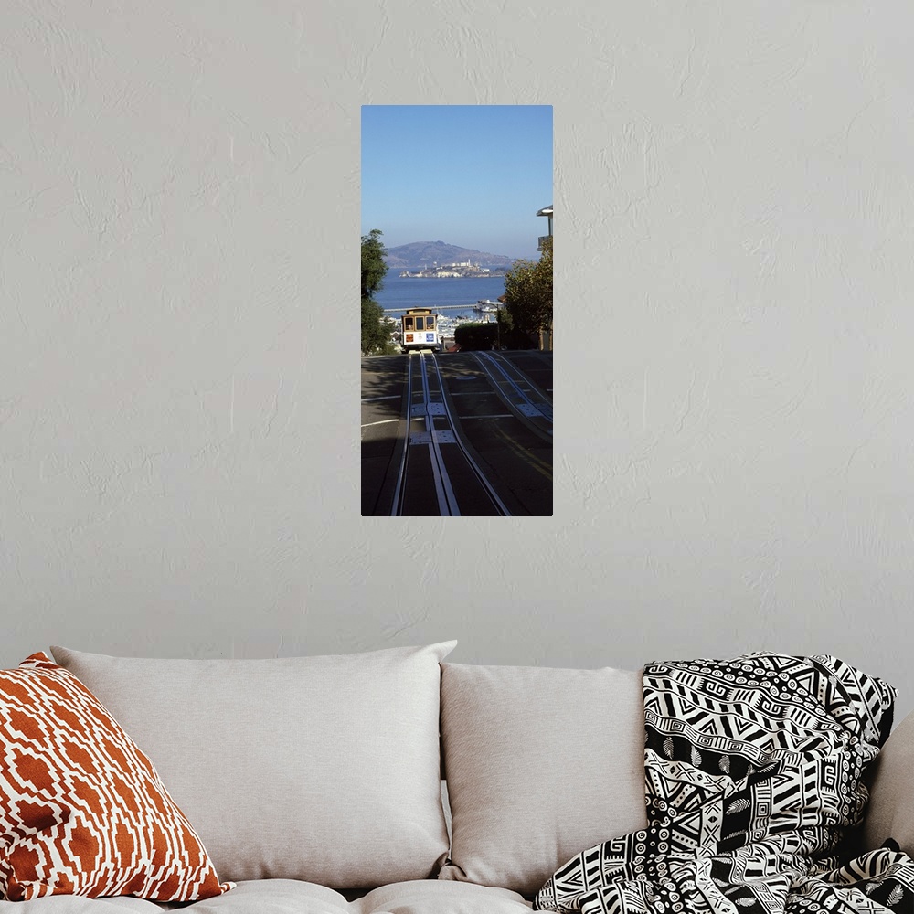 A bohemian room featuring Vertical panoramic photograph of street trolley moving toward the horizon with harbor, waterfront...