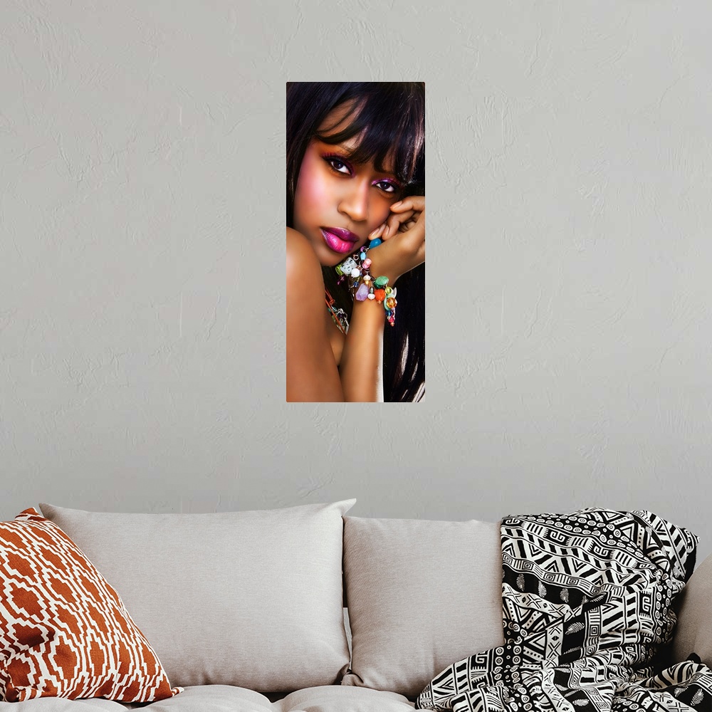 A bohemian room featuring portrait of ayoung black woman looking at camera