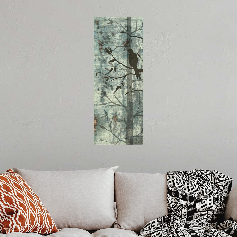 A bohemian room featuring Artwork of silhouetted birds and trees against a pale teal background.