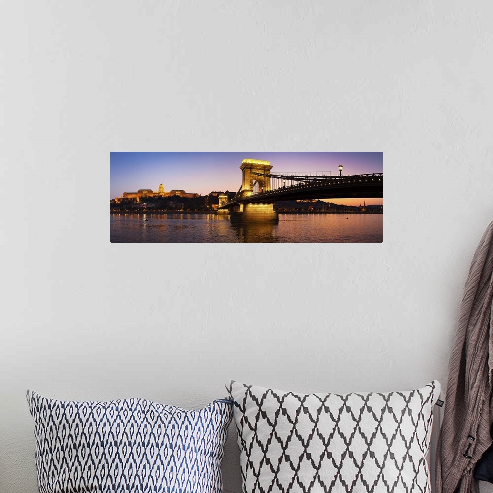 A bohemian room featuring Panoramic photograph of the Chain Bridge in Budapest at dusk.